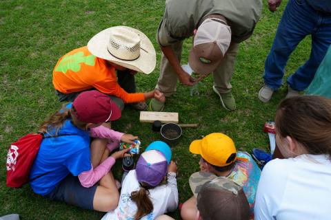 Brian Koch (upper center) demonstrates how to conduct a soil infiltration test.