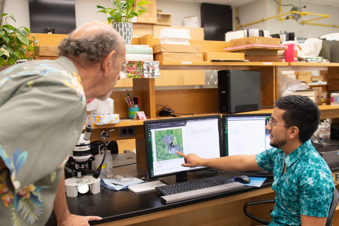 Professor working with student at computer